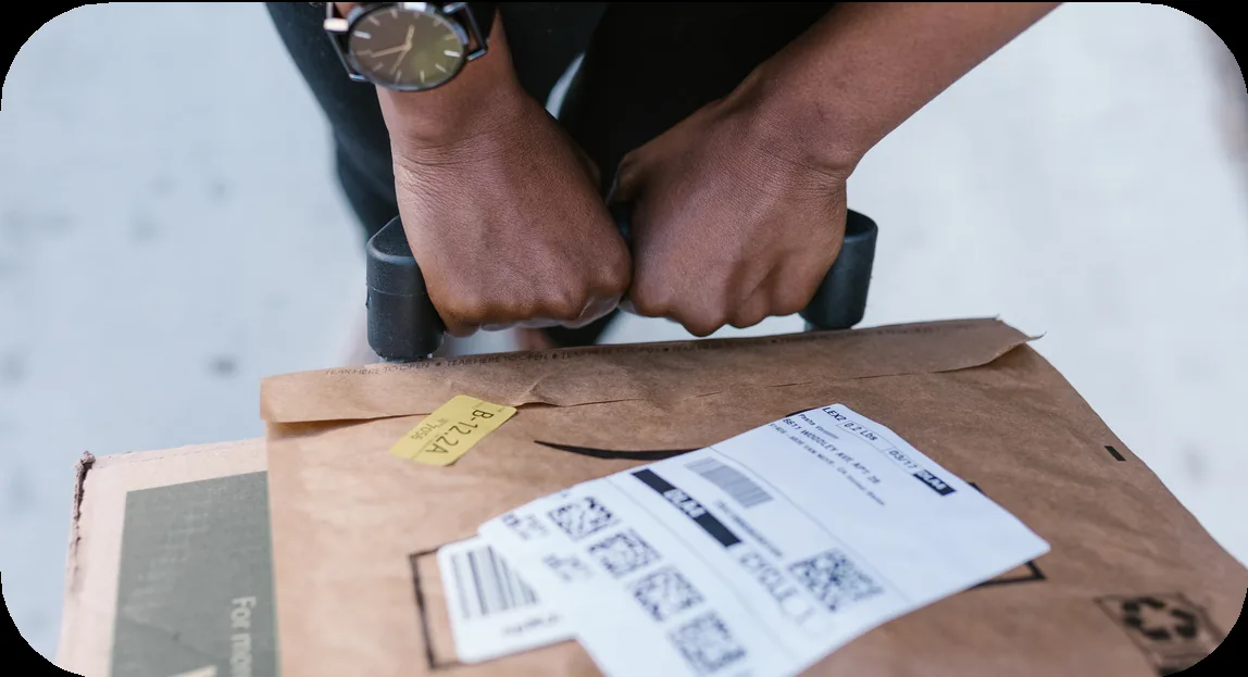Hands checking shipping labels and customs paperwork on a parcel