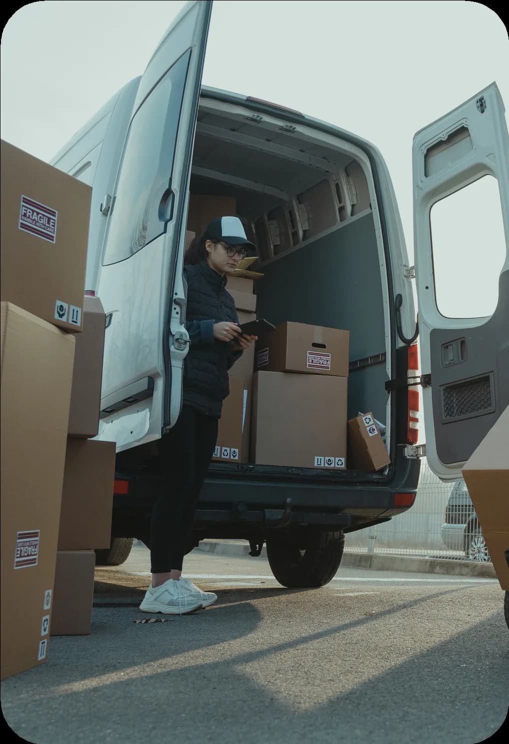Driver loading boxes into the back of a delivery van