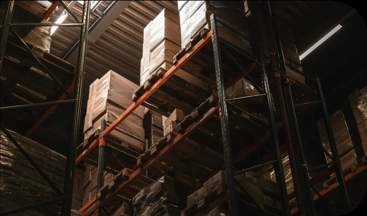 Pallets of boxed goods stacked on warehouse racking